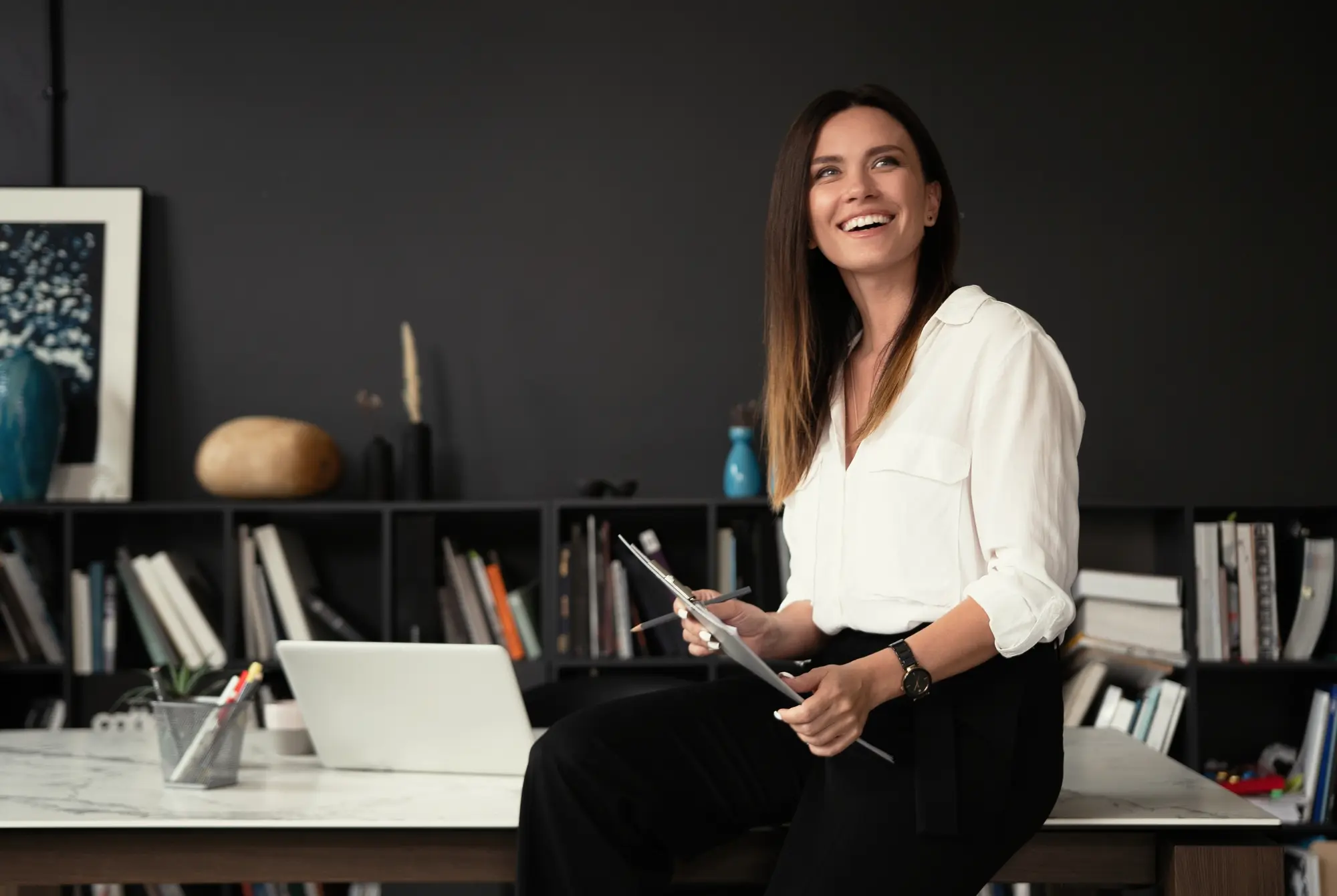 Find a Bookkeeper in New Zealand – Professional Bookkeeping Services Confident stylish middle aged businesswoman standing at her workplace representing bookkeeping services in New Zealand